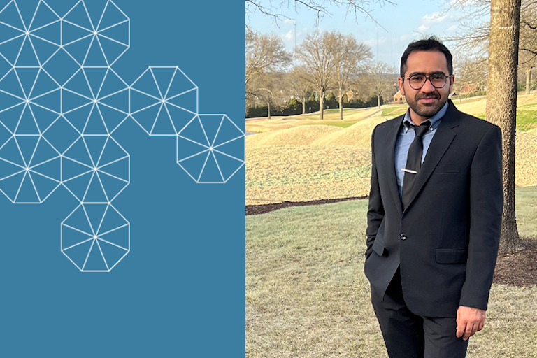 Headshot of postdoctoral researcher Iman Mahdinia, in a dark blue suit with tie, outdoors in a park