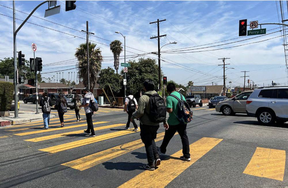 Students crossing at the high-visibility crosswalk on the South Indiana Street/ Percy Street intersection during school dismissal.
