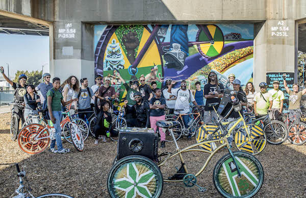 Group photo of participants in a community bike ride event in Oakland, CA
