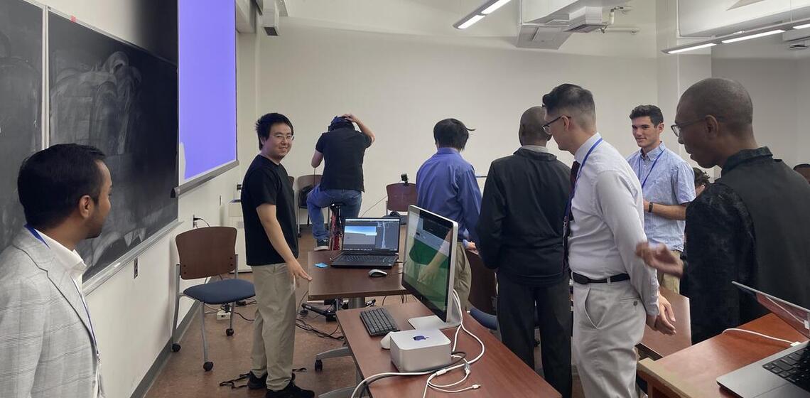 SafeTREC graduate student researcher Han Wang with students at AV simulator workshop