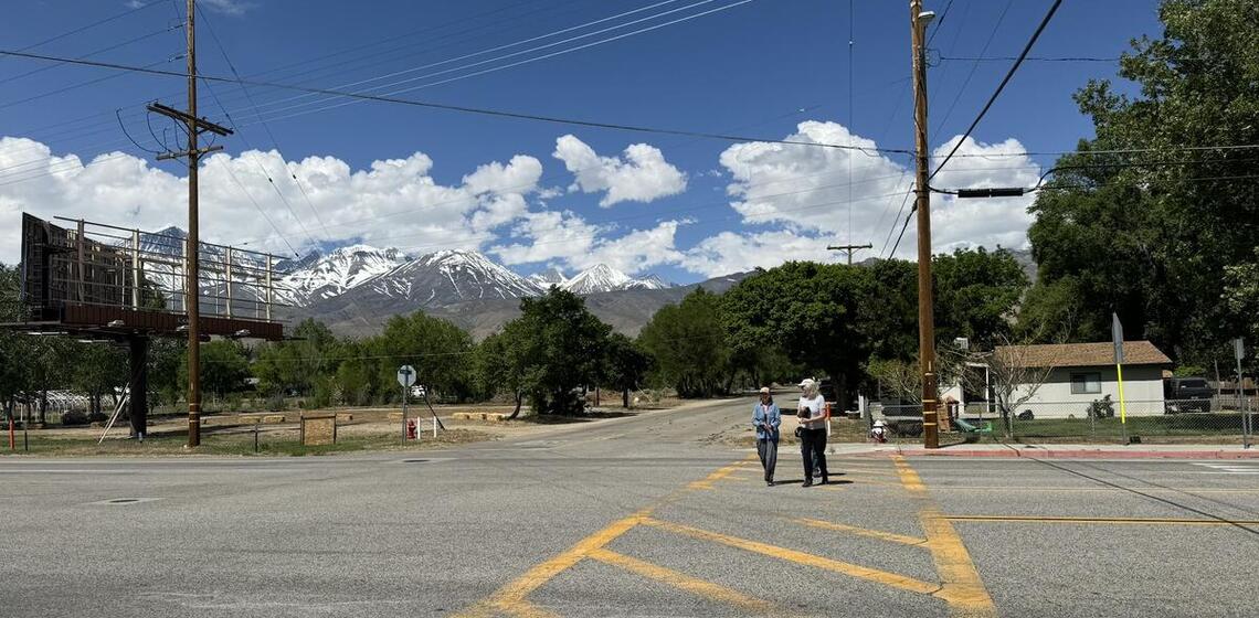 Two people in a crosswalk in Big Pine, CA
