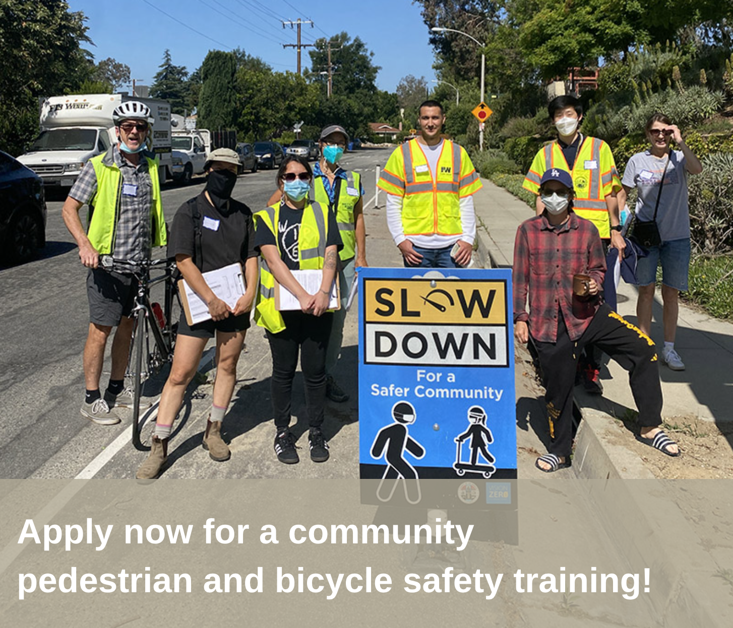 Picture of a group of people next to a safety messaging campaign in Altadena, CA.