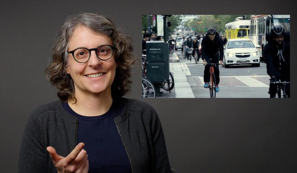 Julia Griswold smiles and points at the camera. To the right is an image of a cyclist biking on a busy street.