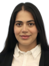 Nikou Khoshnevis Asl, smiling in a white collared shirt with dark black blazer