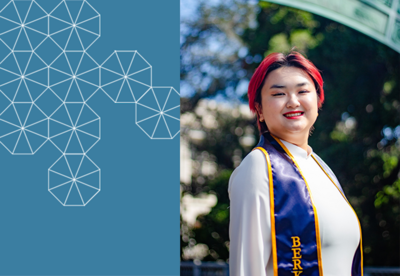 Karen stands smiling facing the camera wearing her UCB graduation sash, with Sather Gate behind her and a blue box with a white tessellation pattern to her left